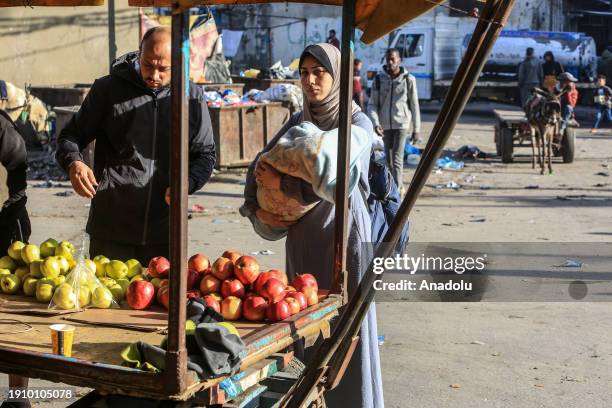 Palestinians try to meet their daily life needs in a bazaar under hard conditions as Israeli attacks continue in Rafah City, Gaza on January 08, 2024.