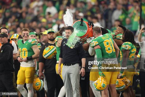 Head coach Dan Lanning of the Oregon Ducks is dunked with gatorade during the final moments of the Fiesta Bowl against the Liberty Flames at State...