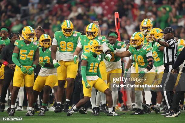Defensive back Rodrick Pleasant of the Oregon Ducks celebrates with teammates after recovering a fumble against the Liberty Flames during the second...