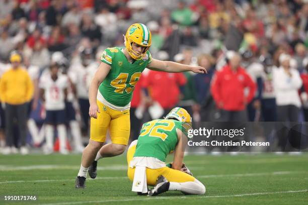 Place kicker Camden Lewis of the Oregon Ducks kicks and extra point against the Liberty Flames during the second half of the Fiesta Bowl at State...