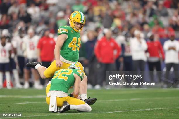 Place kicker Camden Lewis of the Oregon Ducks kicks and extra point against the Liberty Flames during the second half of the Fiesta Bowl at State...