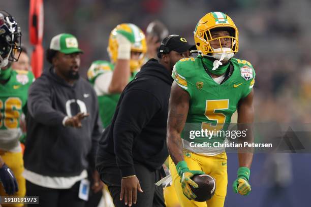 Wide receiver Traeshon Holden of the Oregon Ducks reacts during the first half of the Fiesta Bowl at State Farm Stadium on January 01, 2024 in...