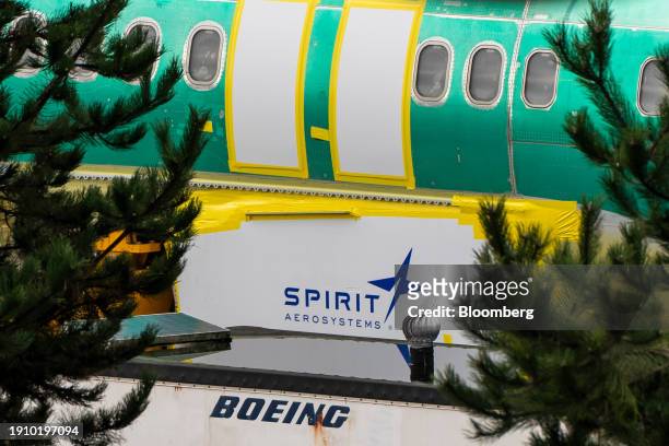 Spirit AeroSystems Holdings Inc. Signage near a Boeing 737 Max 8 aircraft fuselage outside the Boeing Co. Manufacturing facility in Renton,...