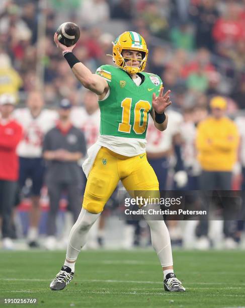 Quarterback Bo Nix of the Oregon Ducks throws a pass during the first half of the Fiesta Bowl against the Liberty Flames at State Farm Stadium on...