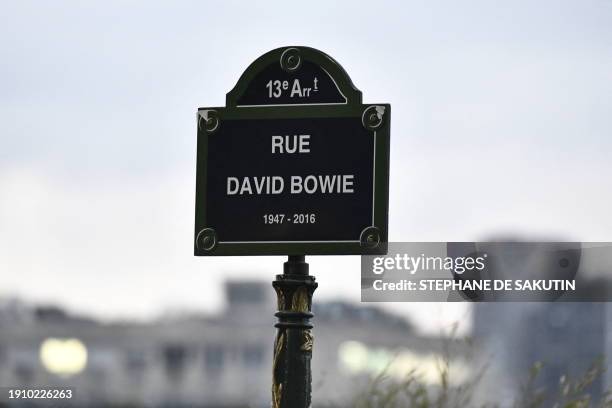 Photo shows a plaque during the inauguration of a street, named after British rock music and pop icon David Bowie, on the day of his 77th birthday,...