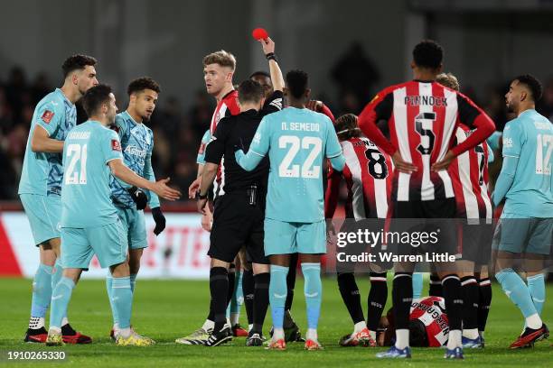 Joao Gomes of Wolverhampton Wanderers is shown a red card by Referee Tony Harrington during the Emirates FA Cup Third Round match between Brentford...