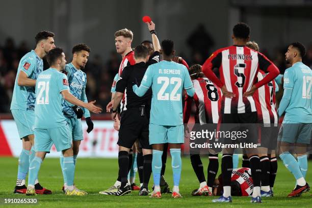 Joao Gomes of Wolverhampton Wanderers is shown a red card by Referee Tony Harrington during the Emirates FA Cup Third Round match between Brentford...