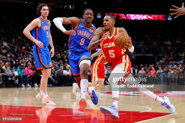 Dejounte Murray of the Atlanta Hawks drives to the basket against Jalen Williams of the Oklahoma City Thunder during the third quarter at State Farm...