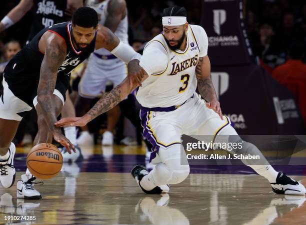 Los Angeles, CA Lakers forward Anthony Davis, #3, right, battles Clippers forward Paul George, #13m for control of a loose ball in the second half at...