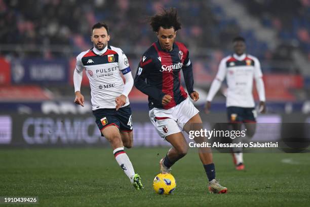 Joshua Zirkzee of Bologna FC runs with the ball whilst under pressure from Milan Badelj of Genoa CFC during the Serie A TIM match between Bologna FC...