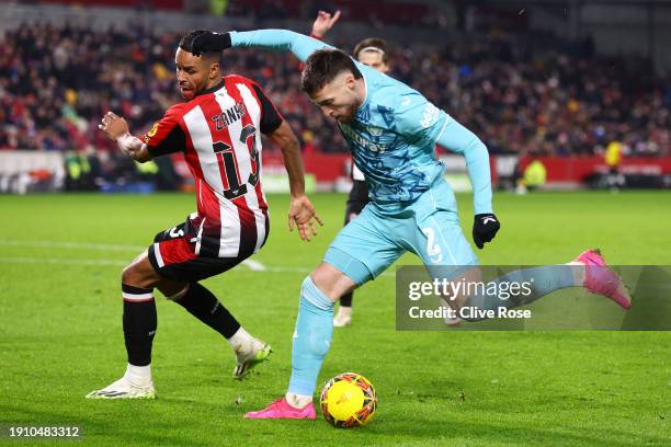 Matt Doherty of Wolverhampton Wanderers runs with the ball whilst under pressure from Mathias Zanka Jorgensen of Brentford during the Emirates FA Cup...