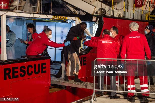 People during the disembarkation operations of a migrant from the Open Arms ship at Salerno Port on January 05, 2024 in Salerno, Italy. 60 migrants...