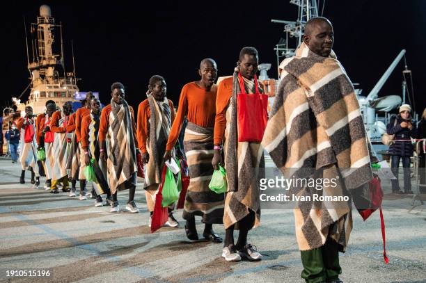 Migrants lined up during disembarkation from the Open Arms ship at Salerno Port on January 05, 2024 in Salerno, Italy. 60 migrants have disembarked...