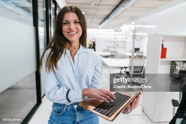 focused entrepreneur working on laptop in modern office - best execution stock pictures, royalty-free photos & images