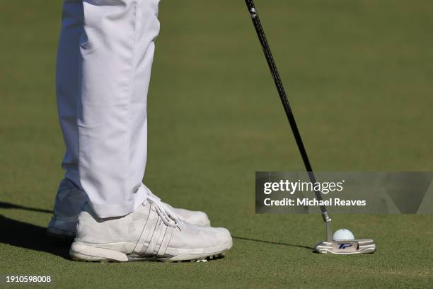 Detailed view of shoes worn by Collin Morikawa of the United States are seen as he putts during the second round of The Sentry at Plantation Course...