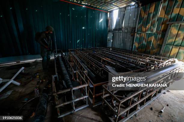 This picture taken during a media tour organised by the Israeli military on January 8 shows long range rockets in a facility that the army claims is...