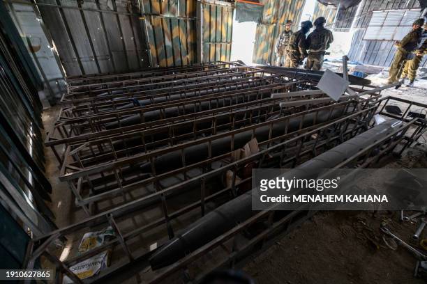 This picture taken during a media tour organised by the Israeli military on January 8 shows long range rockets in a facility that the army claims is...