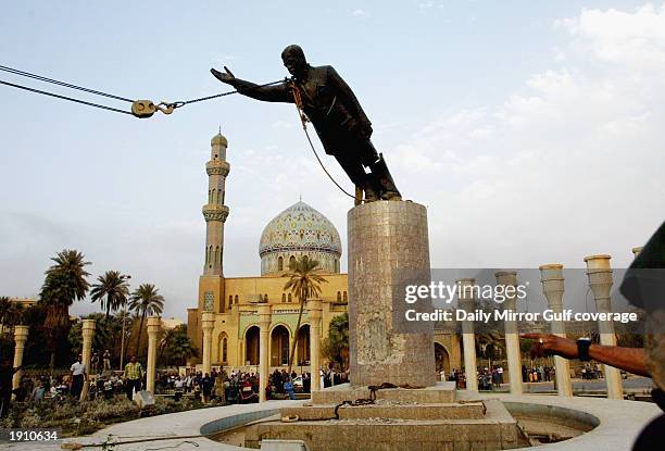 Marines pull down the statue of Saddam Hussein in the centre of Baghdad, April 9, 2003.