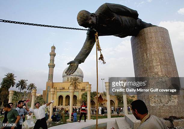 Marines pull down the statue of Saddam Hussein in the centre of Baghdad, April 9, 2003.