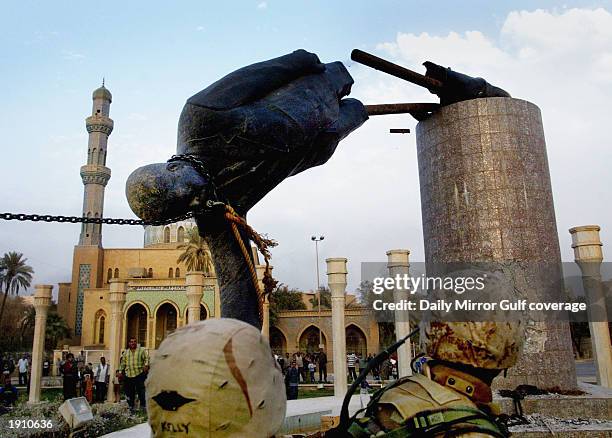 Marines pull down the statue of Saddam Hussein in the centre of Baghdad, April 9, 2003.