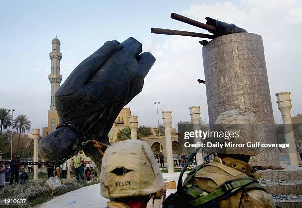 Marines pull down the statue of Saddam Hussein in the centre of Baghdad, April 9, 2003.