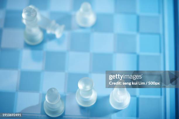 high angle view of chess pieces on board - rook chess piece stock pictures, royalty-free photos & images