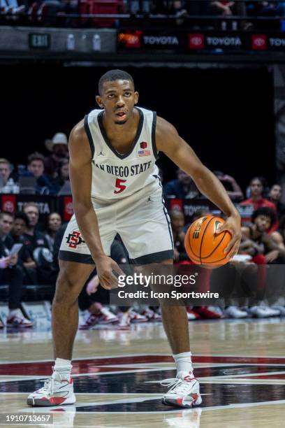 San Diego State guard Lamont Butler dribbles in the second half of a college basketball game between the UNLV Runnin' Rebels and the San Diego State...