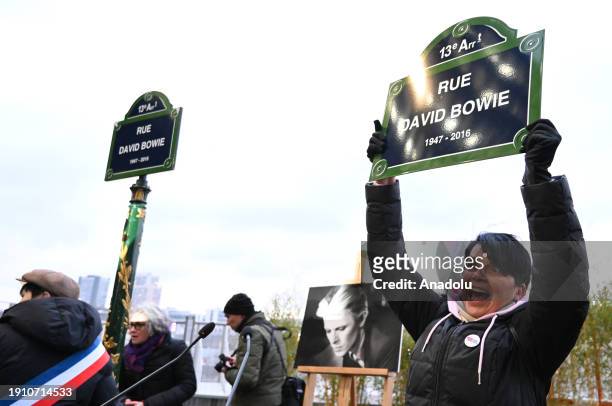 Person holds street plate of David Bowie, during the inauguration of British rock music and pop icon David Bowie street, on the day of his 77th...