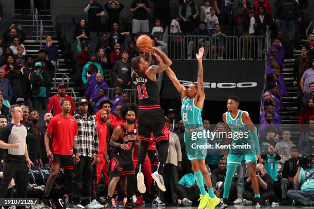 DeMar DeRozan of the Chicago Bulls shoots a three point basket during the game against the Charlotte Hornets on January 8, 2024 at Spectrum Center in...