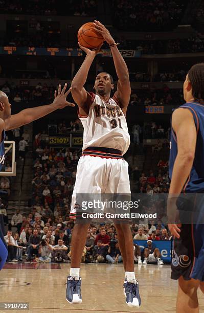 Nene Hilario of the Denver Nuggets shoots a jump shot during the NBA game against the Washington Wizards at Pepsi Center on March 30, 2003 in Denver,...