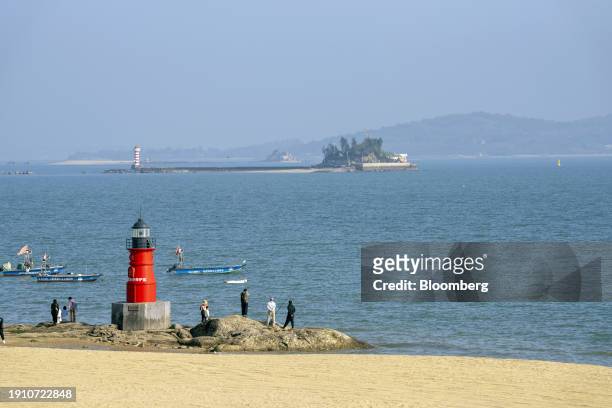 People on a beach in front of Kinmen island in Xiamen, China, on Friday, Jan. 5, 2024. Chinese authorities indicated they may lower the amount of...