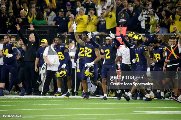 Michigan celebrates winning the game as time expires on the clock during the Michigan Wolverines versus the Washington Huskies CFP National...