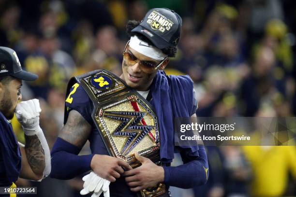 Will Johnson of the Michigan Wolverines celebrates winning the game with a championship belt during the Michigan Wolverines versus the Washington...