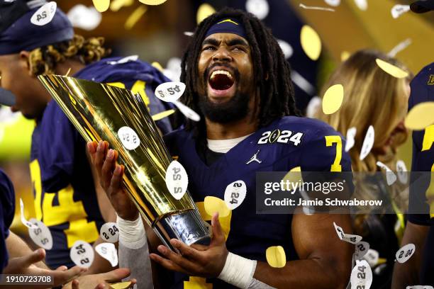 Donovan Edwards of the Michigan Wolverines celebrates with the trophy after defeating the Washington Huskies 34-13 in the 2024 CFP National...