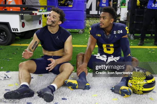 Michigan Wolverines wide receiver Roman Wilson and Michigan Wolverines wide receiver Cornelius Johnson sit on the side of the field after winning the...