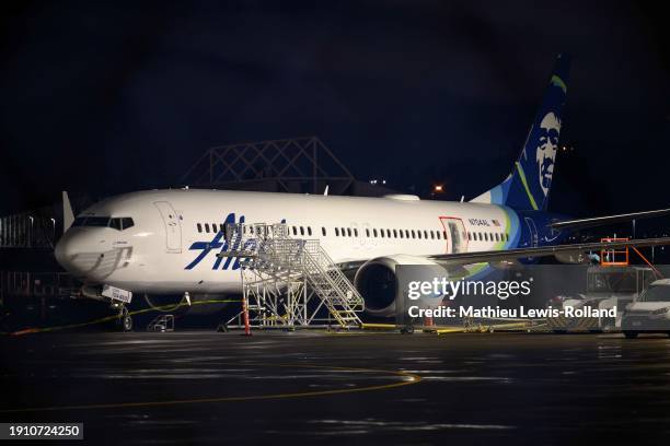 Plastic sheet covers an area of the fuselage of the Alaska Airlines N704AL Boeing 737 MAX 9 aircraft outside a hangar at Portland International...