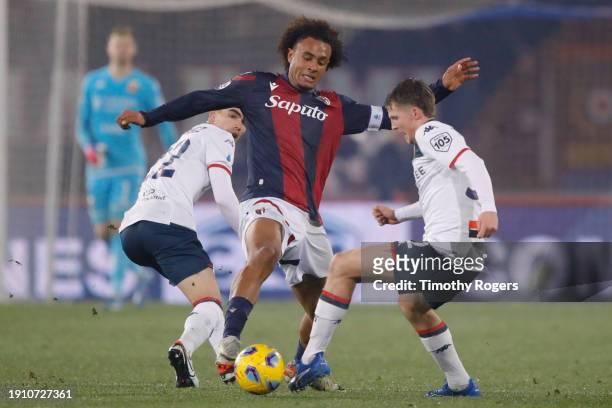 Joshua Zirkzee of Bologna challenges Morten Frendrup of Genoa for the ball during the Serie A TIM match between Bologna FC and Genoa CFC at Stadio...