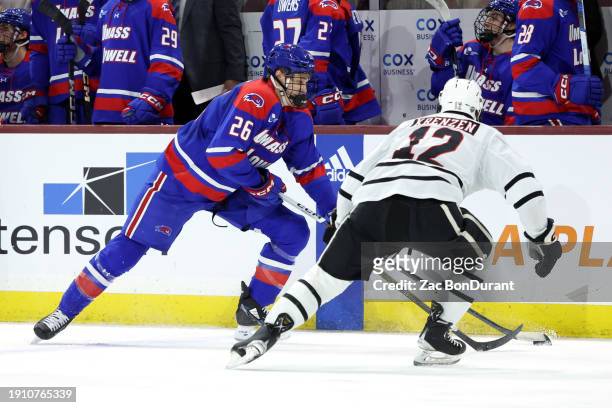 Nick Rhéaume of the UMass Lowell skates with the puck against Nolan Krenzen of the Omaha during the second period at Mullett Arena on January 05,...