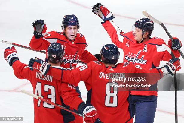 Dylan Strome of the Washington Capitals celebrates with teammates after scoring a goal against the Carolina Hurricanes during the first period at...