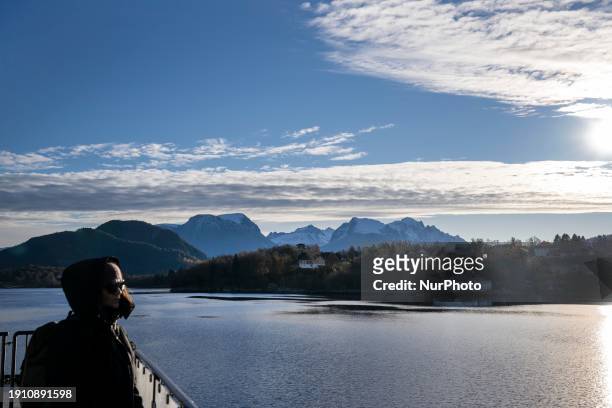 Person is observing the different rock formations and scenery of the Geiranger Fjord from a boat in More og Romsdal, Norway, on November 7, 2023....