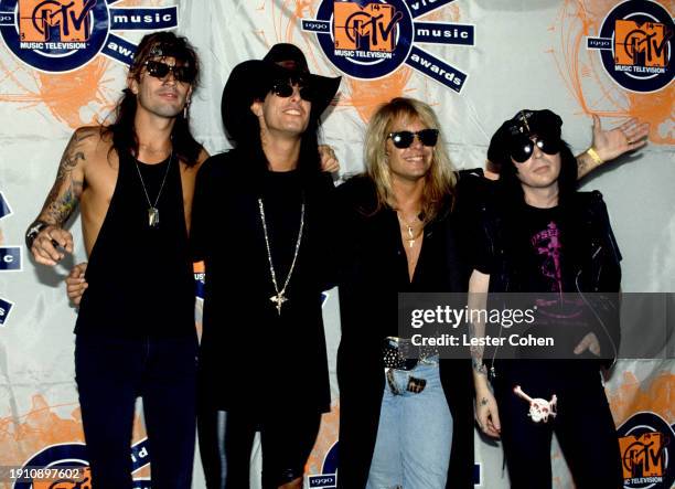 American musicians Tommy Lee, Nikki Sixx, Vince Neil and Mick Mars, of the American heavy metal band Mötley Crüe, pose for a group portrait backstage...