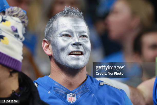 Fan with silver facepaint looks onto the field from the stands during an NFL football game between the Detroit Lions and the Minnesota Vikings in...