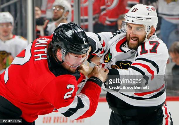 Nick Foligno of the Chicago Blackhawks and Brendan Smith of the New Jersey Devils fight during the second period at Prudential Center on January 05,...