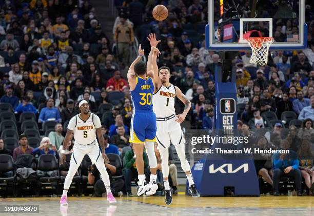 Stephen Curry of the Golden State Warriors shoots over Michael Porter Jr. #1 of the Denver Nuggets during the third of an NBA basketball game quarter...