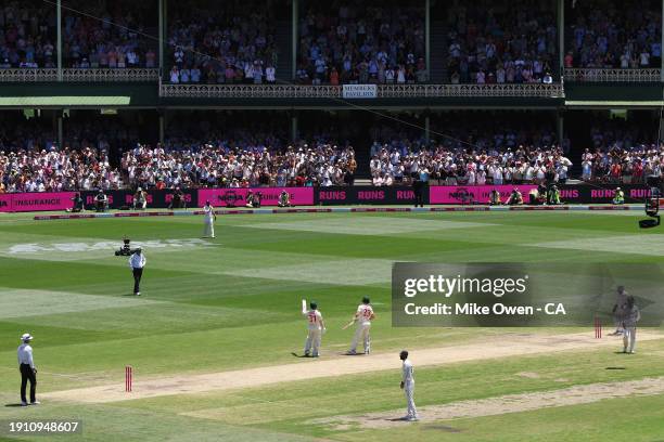 David Warner of Australia celebrates after scoring a half century during day four of the Men's Third Test Match in the series between Australia and...