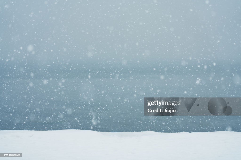 Falling Snowflakes against sky