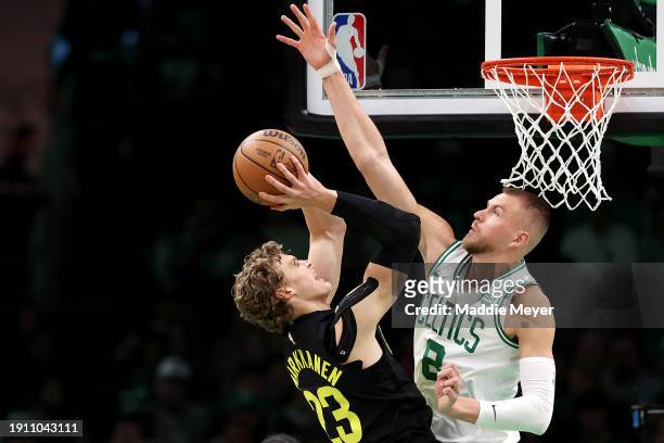 Kristaps Porzingis of the Boston Celtics defends a shot from Lauri Markkanen of the Utah Jazz during the first quarter at TD Garden on January 05,...
