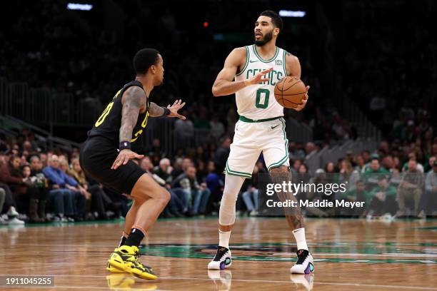 John Collins of the Utah Jazz defends Jayson Tatum of the Boston Celtics during the first quarter at TD Garden on January 05, 2024 in Boston,...