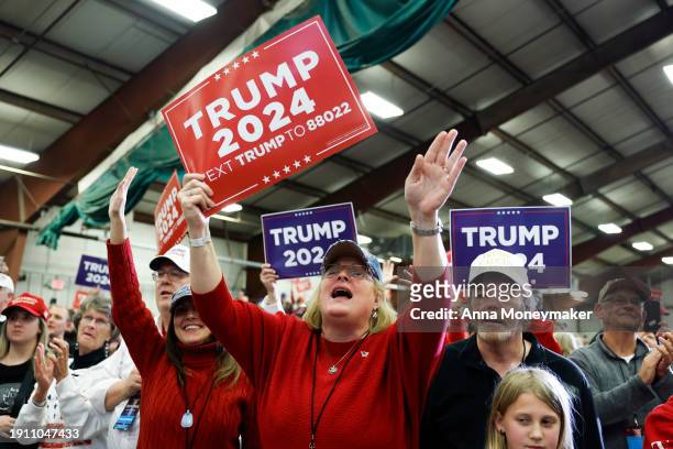 Audience members cheer as Republican presidential candidate, former U.S. President Donald Trump arrives at a campaign rally on January 05, 2024 in...