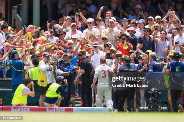 David Warner of Australia leaves the ground for his final test match after being bowled LBW by Sajid Khan of Pakistan during day four of the Men's...